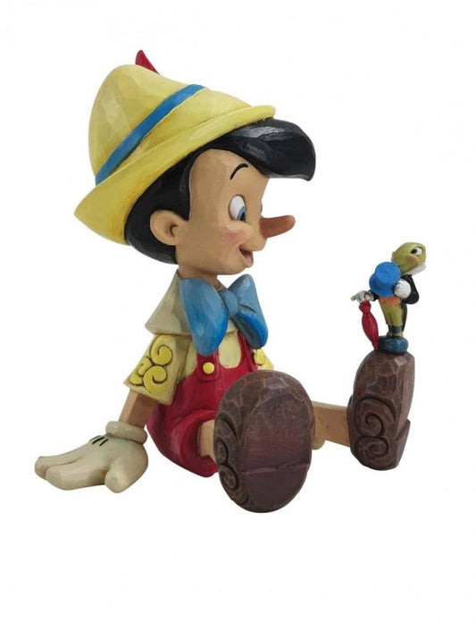 DISNEY TRADITIONS Pinocchio seduto e il grillo